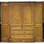 A Regency mahogany breakfront linen press wardrobe with overall coromandel crossbanding, the two