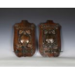 A pair of Edwardian Arts and Crafts oak and patinated copper single-light wall sconces, detailed '