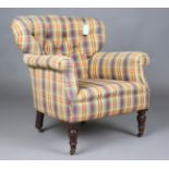 A late Victorian tub back armchair, upholstered in chequered cotton, on turned mahogany legs, height