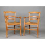 A pair of late 20th century French beech framed kitchen carver chairs with rush seats, height