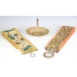 An early 20th century woolwork bell pull with floral decoration against a mustard yellow ground,