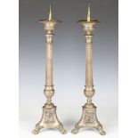 A pair of 20th century silvered cast metal pricket candlesticks, the tapering fluted bodies above