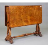 A mid-Victorian burr walnut rectangular Sutherland table, raised on turned legs and carved scroll