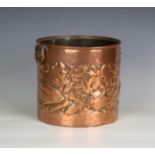 An Arts and Crafts Newlyn copper cylindrical jardinière, the body repoussé decorated with fish,