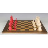 A late 19th century turned bone and red stained chess set, height of king 11cm, together with a