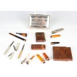 A group of smoking related items, including four 9ct gold mounted amber cheroots, two silver mounted
