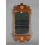 A 19th century George III style walnut fretwork wall mirror with two parcel gilt rosettes, height