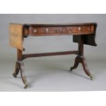 A Regency mahogany sofa table, the shaped top above two frieze drawers above block supports and