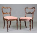 Two similar sets of four William IV rosewood spoon back dining chairs with finely carved centre