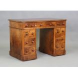 A mid-Victorian burr walnut twin pedestal desk, the top inset with gilt-tooled claret leather