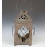 A late 19th century Arts and Crafts patinated copper hanging lantern, the pierced hood enclosing a