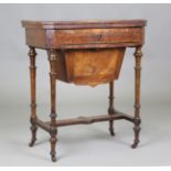 A late Victorian burr walnut and amboyna crossbanded games/work table, the hinged top revealing