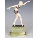 An Art Deco cast gilt bronze and carved ivory full-length figure of a dancer, attributed to