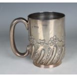 An Edwardian silver tankard of cylindrical form with loop handle and half spiral reeded and beaded