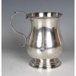 A late Victorian silver baluster tankard with scroll handle and circular stepped foot, London 1897