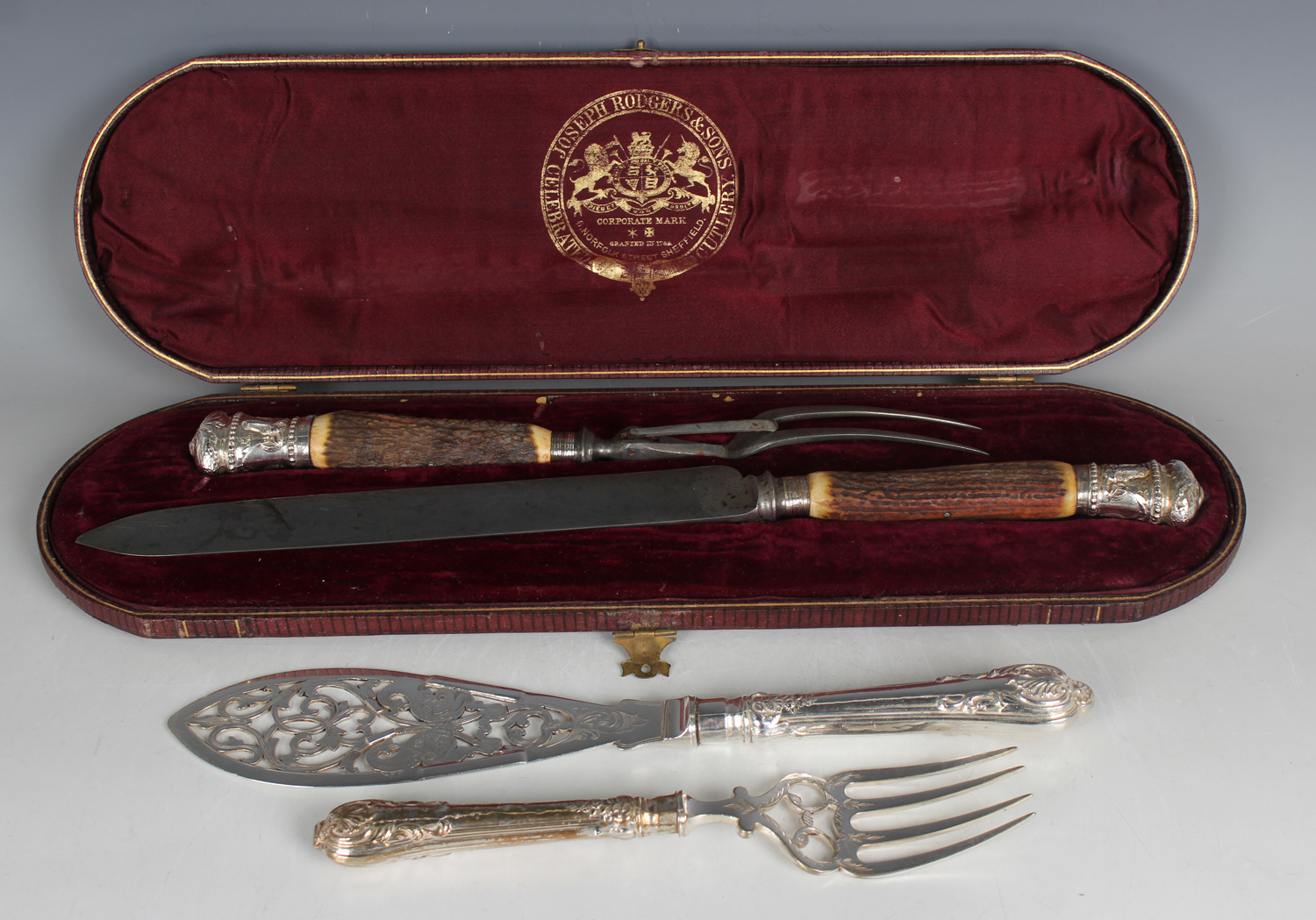 A silver mounted stag antler handled two-piece carving knife and fork set with steel blade and