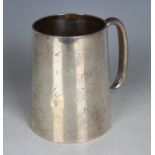 An Indian colonial silver tankard of tapering cylindrical form with loop handle, the body engraved