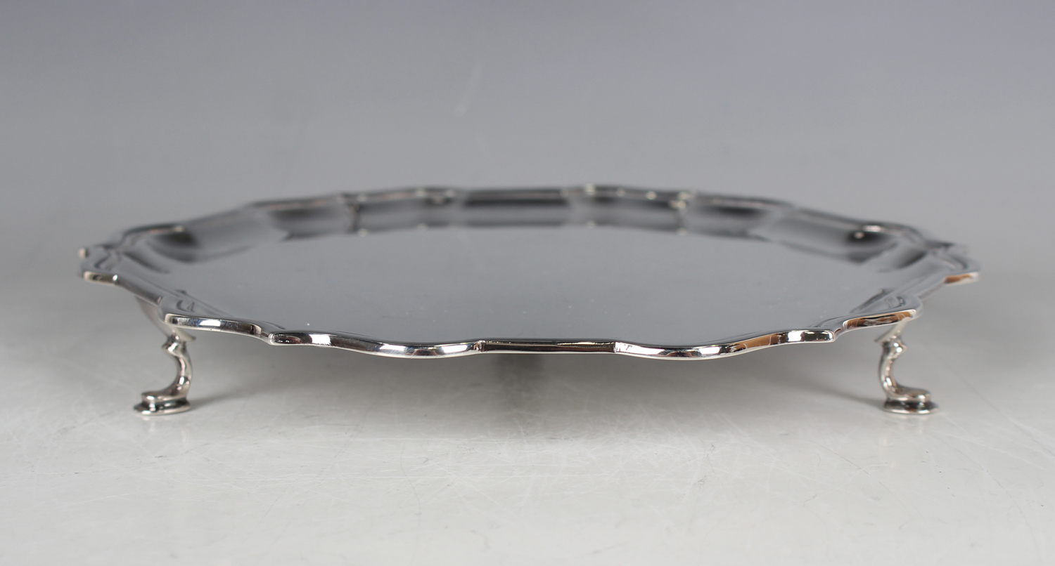 An Elizabeth II silver circular card salver with reeded scroll rim, raised on scroll legs - Image 4 of 4