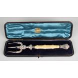 A Victorian silver and ivory handled serving fork with reeded and scroll decoration, Birmingham 1889