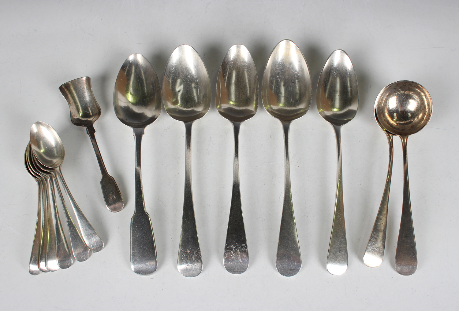 A mixed group of mostly Georgian silver flatware, comprising a pair of Old English pattern sauce