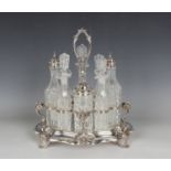 A late Victorian plated eight-bottle cruet stand with central scroll handle above swan supports,