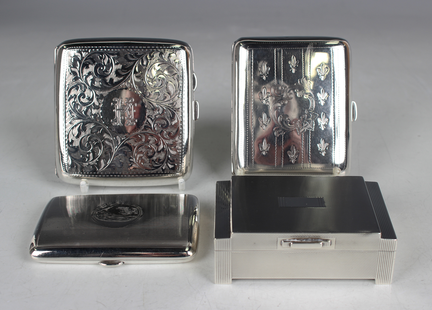 Three silver curved rectangular cigarette cases, one with engine turned decoration, Birmingham