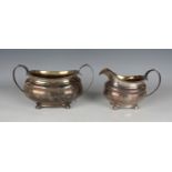 A George IV silver two-handled sugar bowl and matching milk jug, each of cushion form with reeded