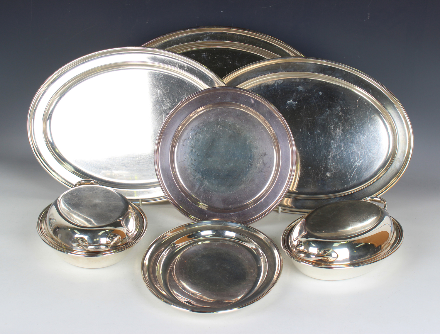 A group of plated items, including a set of four graduated oval platters, a pair of oval entrées