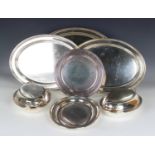 A group of plated items, including a set of four graduated oval platters, a pair of oval entrées