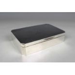 A George V silver canted corner rectangular cigarette box, the engine turned hinged lid with