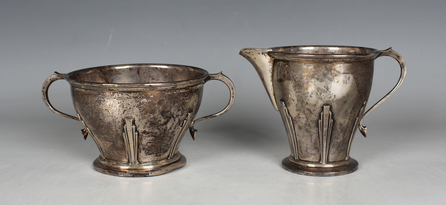 An Art Deco silver two-handled sugar bowl and matching milk jug, each of tapering form, cast in