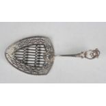 A George III silver fish slice with pierced scroll handle and geometric pierced blade united by a
