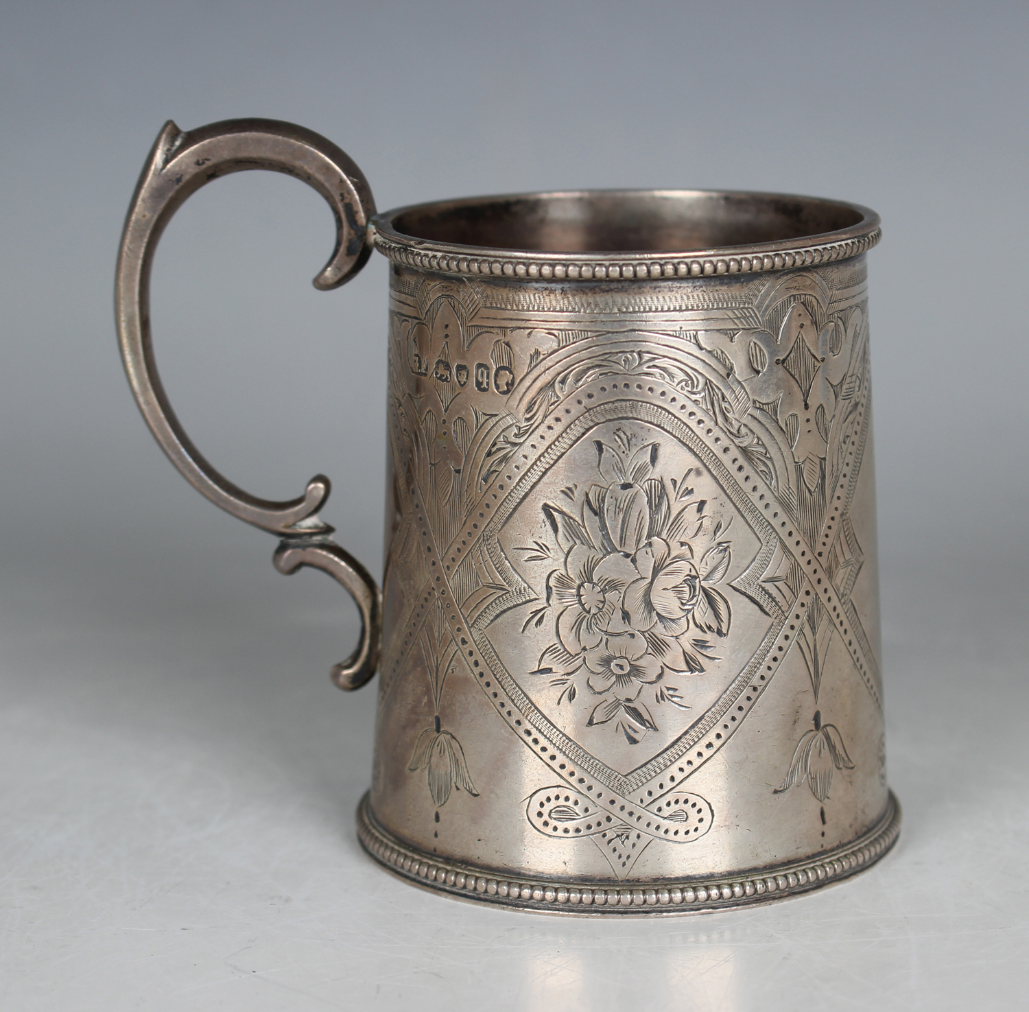 A Victorian silver tapering cylindrical christening tankard with scroll handle, the body engraved