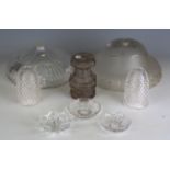 A large collection of cut and moulded glass light fittings, including shades, drops, sconces and