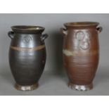 Two German stoneware storage jars with applied loop handles, height 56cm and 53cm.Buyer’s Premium