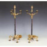 A pair of Regency gilt and brown patinated cast bronze four-light candelabra converted to