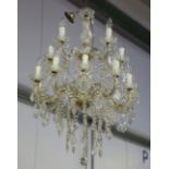 A mid-20th century moulded and cut glass mounted two-tier fourteen-light chandelier, hung with