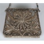 A late 19th century silver filigree lady's purse with hinged top, all-over foliate decoration and