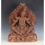 A 20th century Balinese carved hardwood figure of a deity seated upon a lotus leaf shrine, height