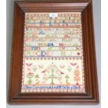 A Victorian needlework alphabet sampler by Jane Cunnison, dated 1864, with central tree surrounded