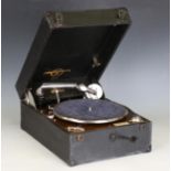 A group of three Columbia portable mechanical gramophones, one with a dark blue rexine case, two
