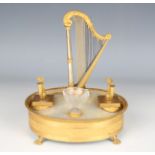 A late 19th century French Classical Revival gilt metal and mother-of-pearl oval musical desk stand,