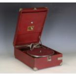 An HMV portable mechanical gramophone with a burgundy rexine case and No. 4 sound box, width 29cm.