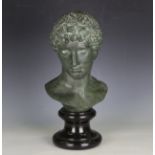 A 20th century green patinated cast bronze museum copy bust of a young classical athlete, raised