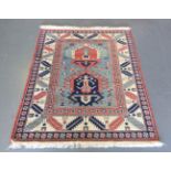 A Turkish 'Kazak' design rug, late 20th century, the blue field with two hooked medallions, within