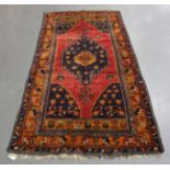 A Hamadan rug, North-west Persia, late 20th century, the red field with a stepped medallion,