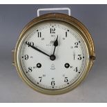 A 20th century lacquered brass ship's clock with eight day movement striking hours and half hours,