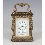 A late 20th century brass diminutive carriage timepiece, the white enamel dial with Roman hour