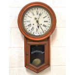 An early 20th century American Ansonia Clock Company walnut cased drop dial calendar wall clock with