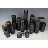A collection of assorted camera lenses, including Tokina 80-200mm zoom lens, Fujinon 75-150mm zoom